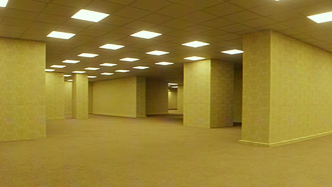 An empty fluorescent-lit backroom with yellow walls and beige carpet receding into the distance
